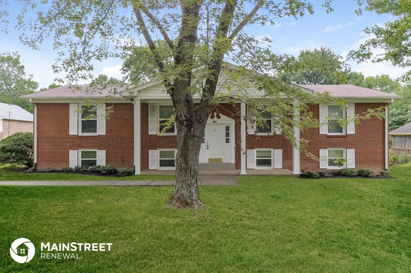 a brick house with a tree in front of it