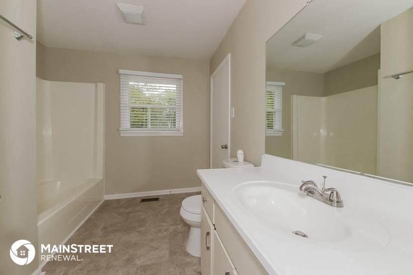 a bathroom with a sink and a toilet and a mirror