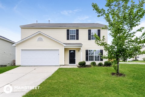 a white house with black shutters and a white garage door