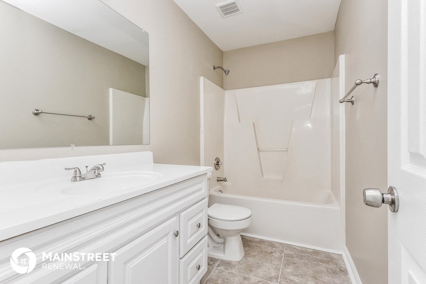 a bathroom with a sink and a toilet and a shower