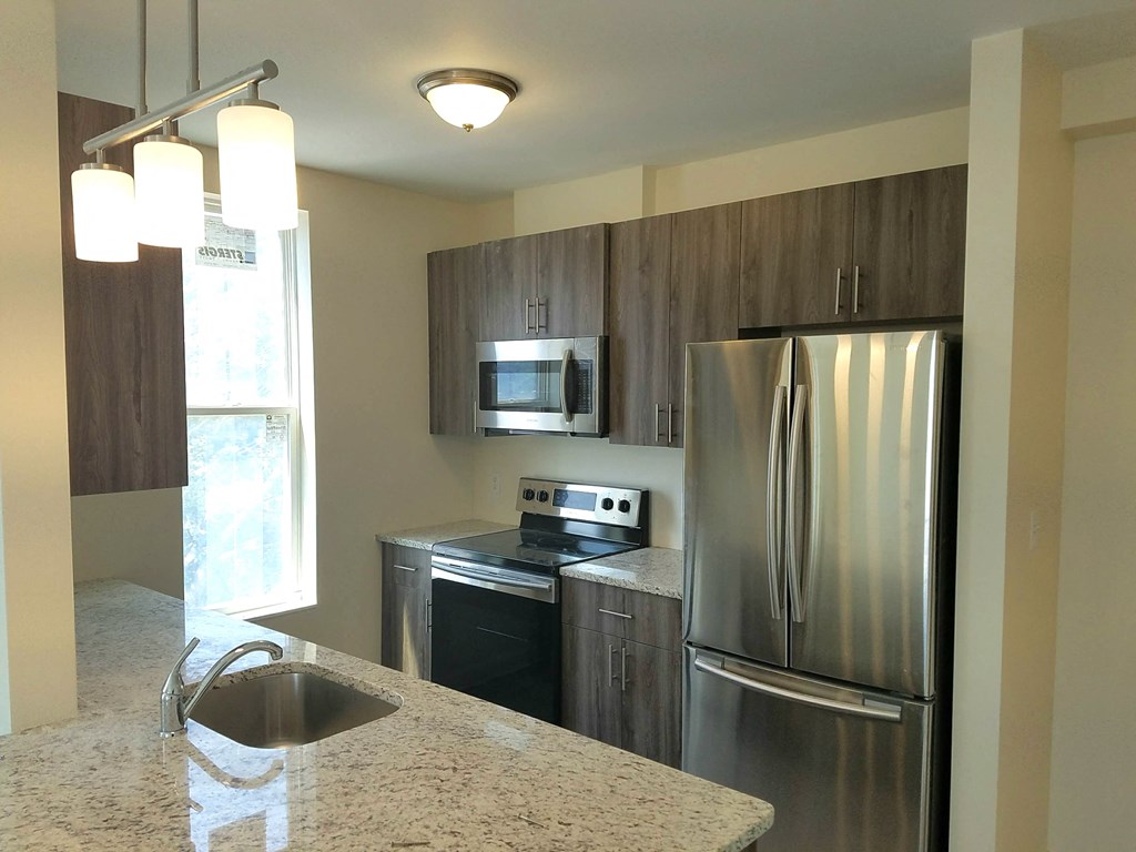 a kitchen with stainless steel appliances and granite counter tops