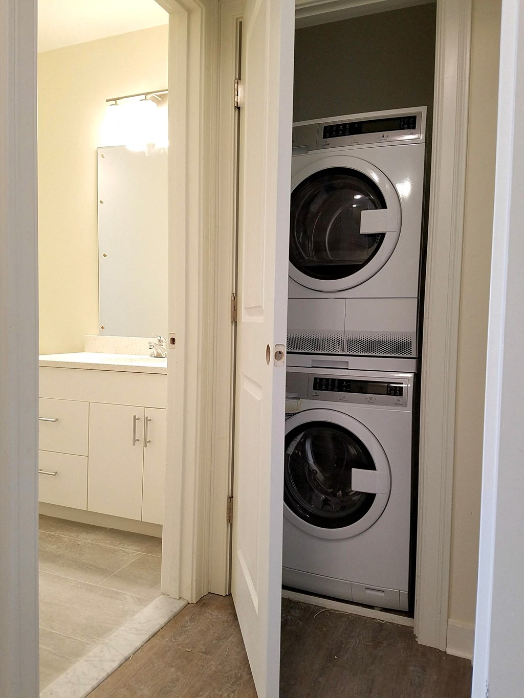 a washer and dryer combo in a small closet in a bathroom