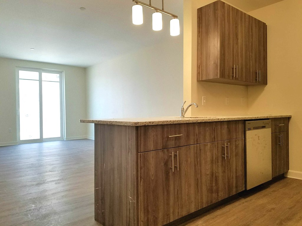 an empty kitchen with wooden cabinets and a counter top