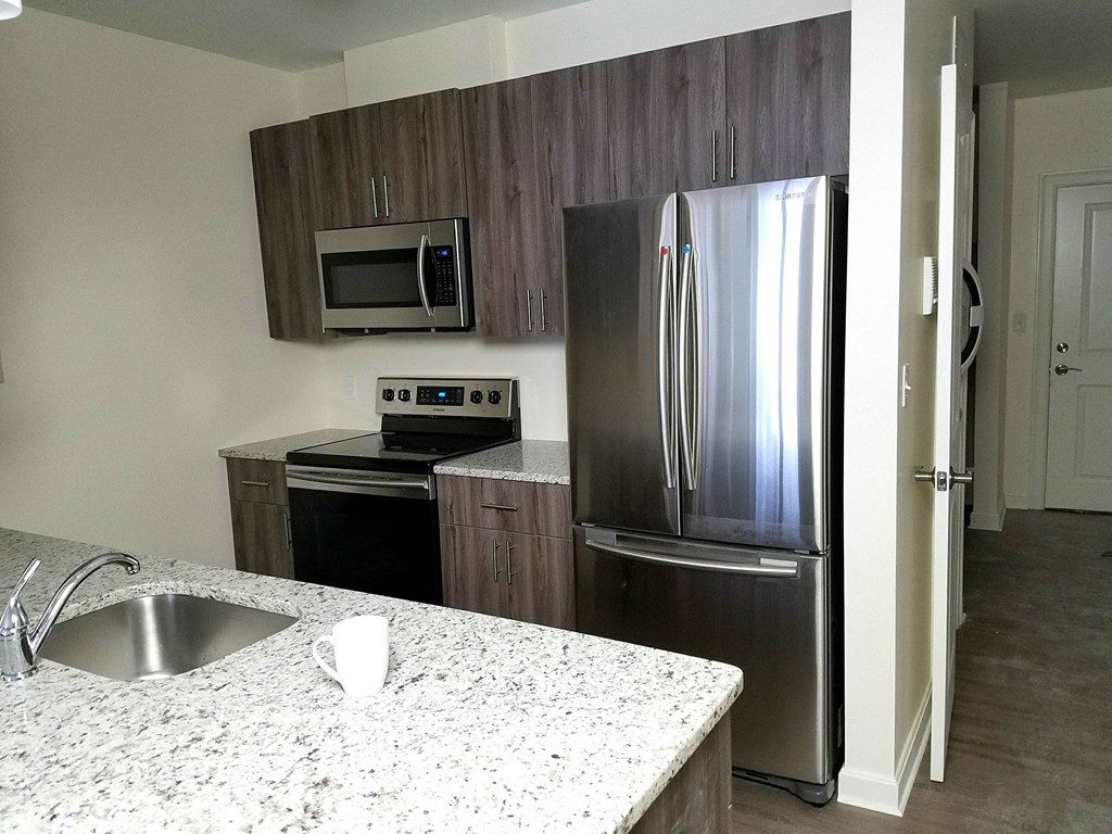 a kitchen with stainless steel appliances and granite counter tops