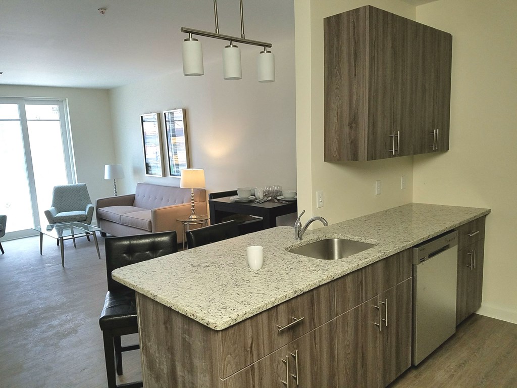 a kitchen with an island and a living room with a couch