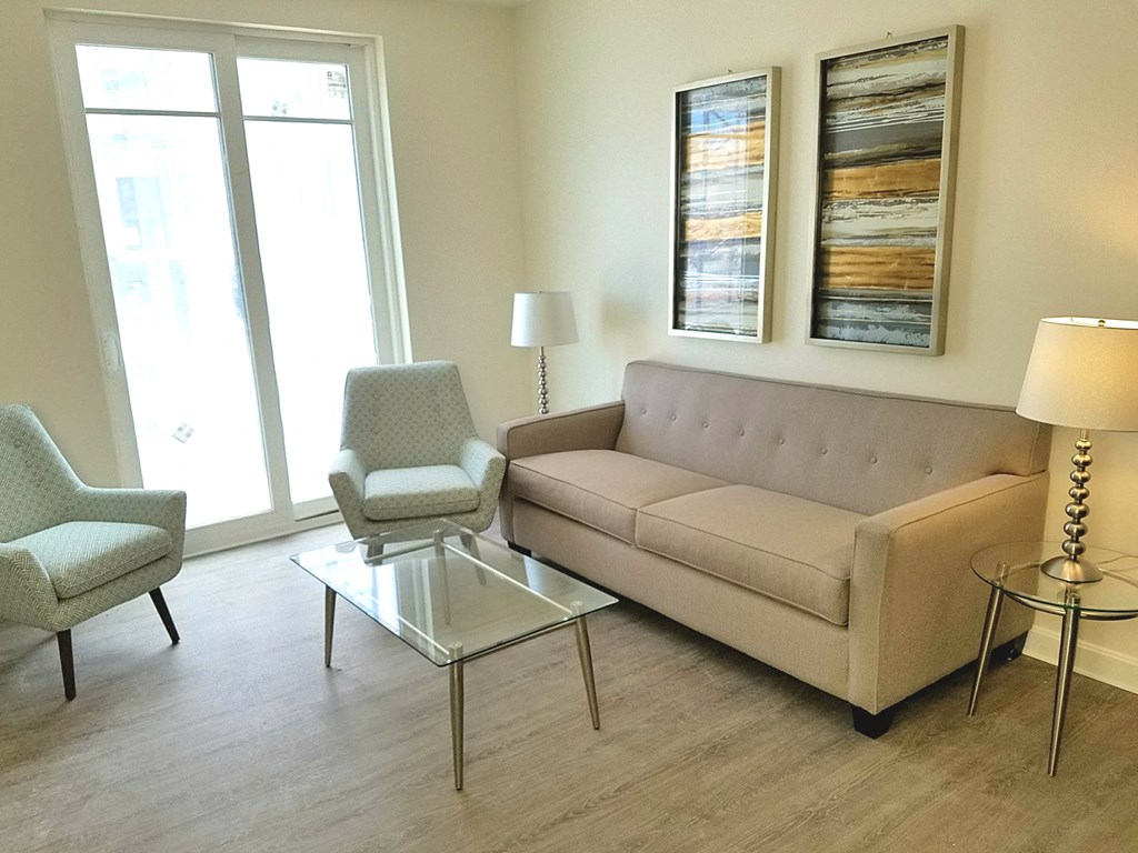 a living room with a couch and two chairs