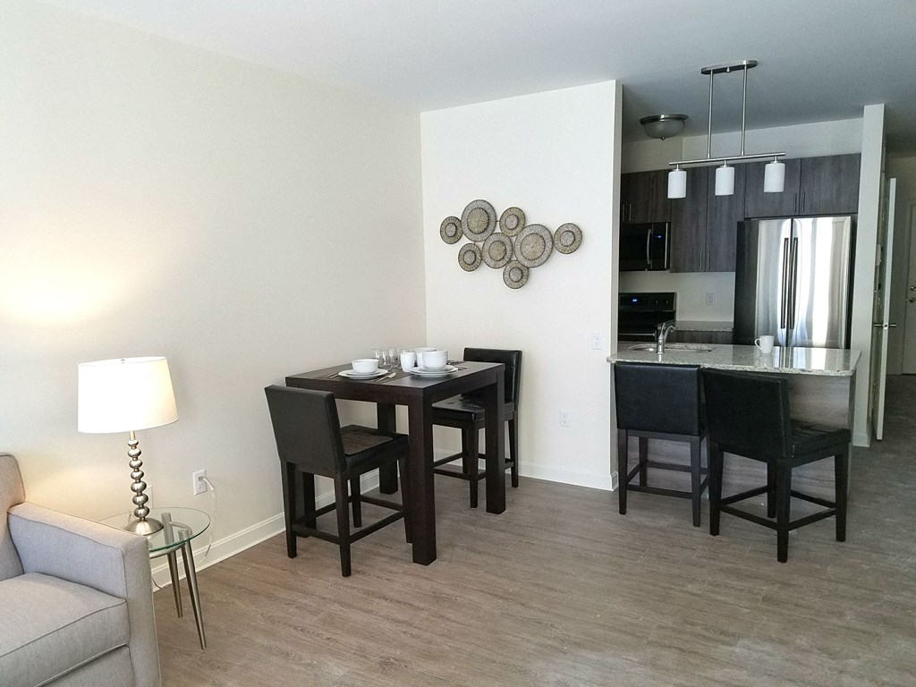 a living room with a dining room table and a kitchen