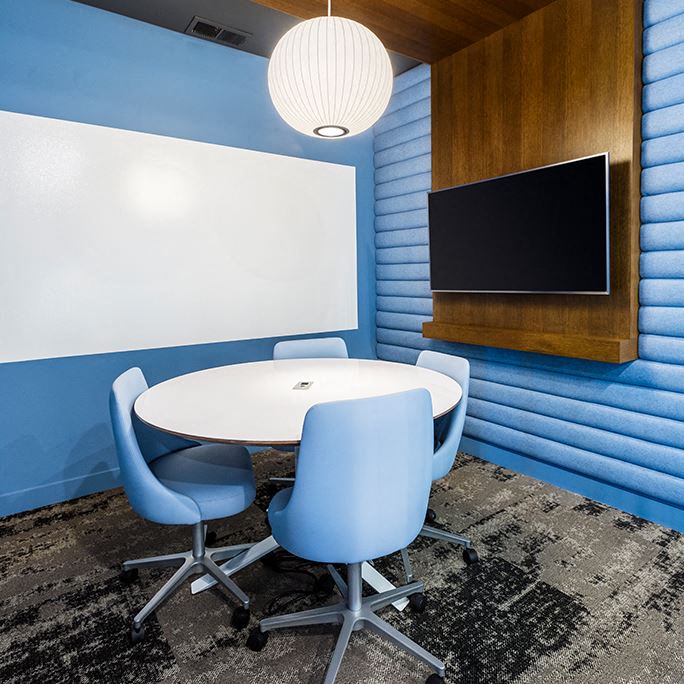 a conference room with a table and chairs