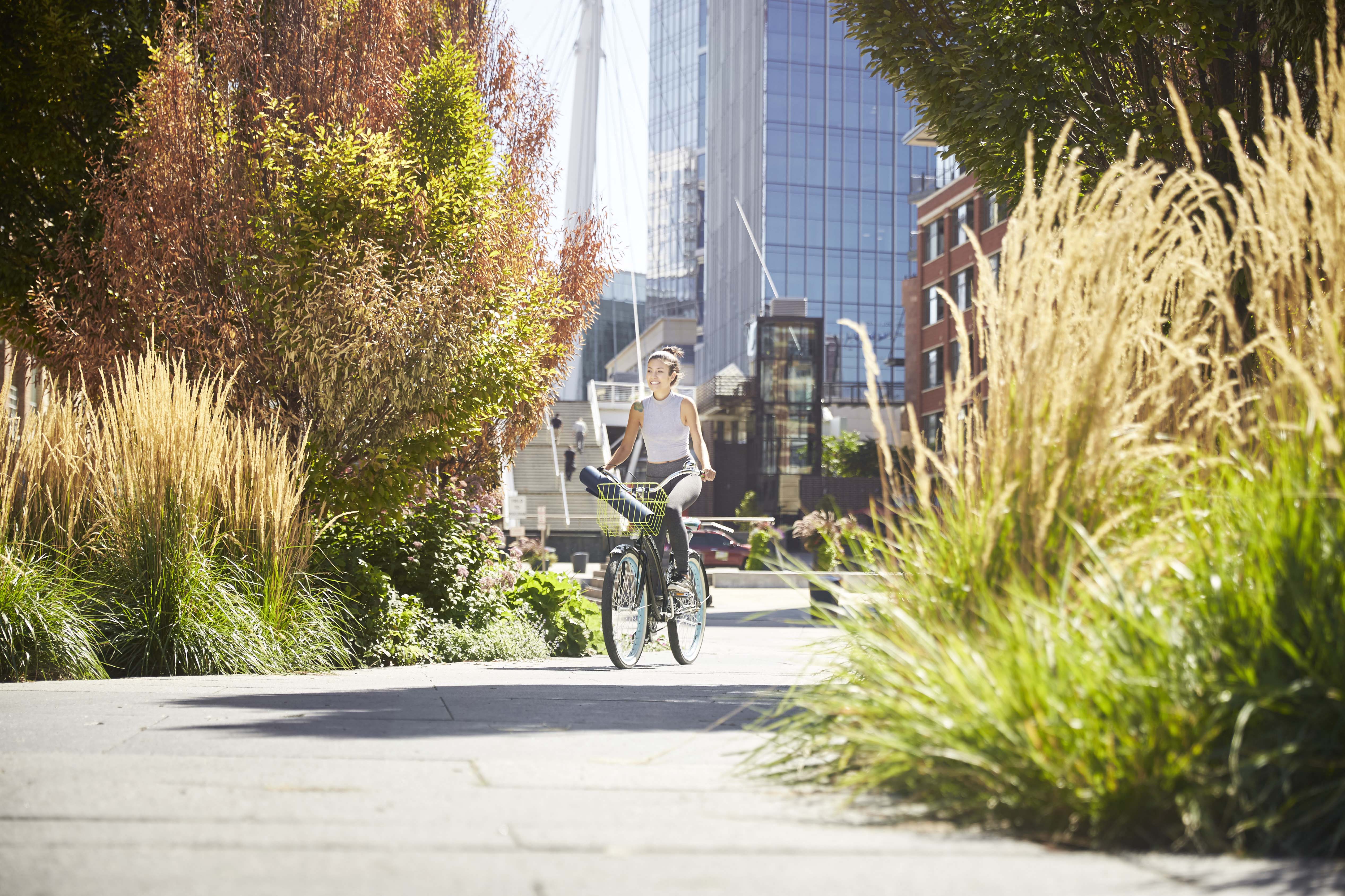 a man riding a bike down a city sidewalk