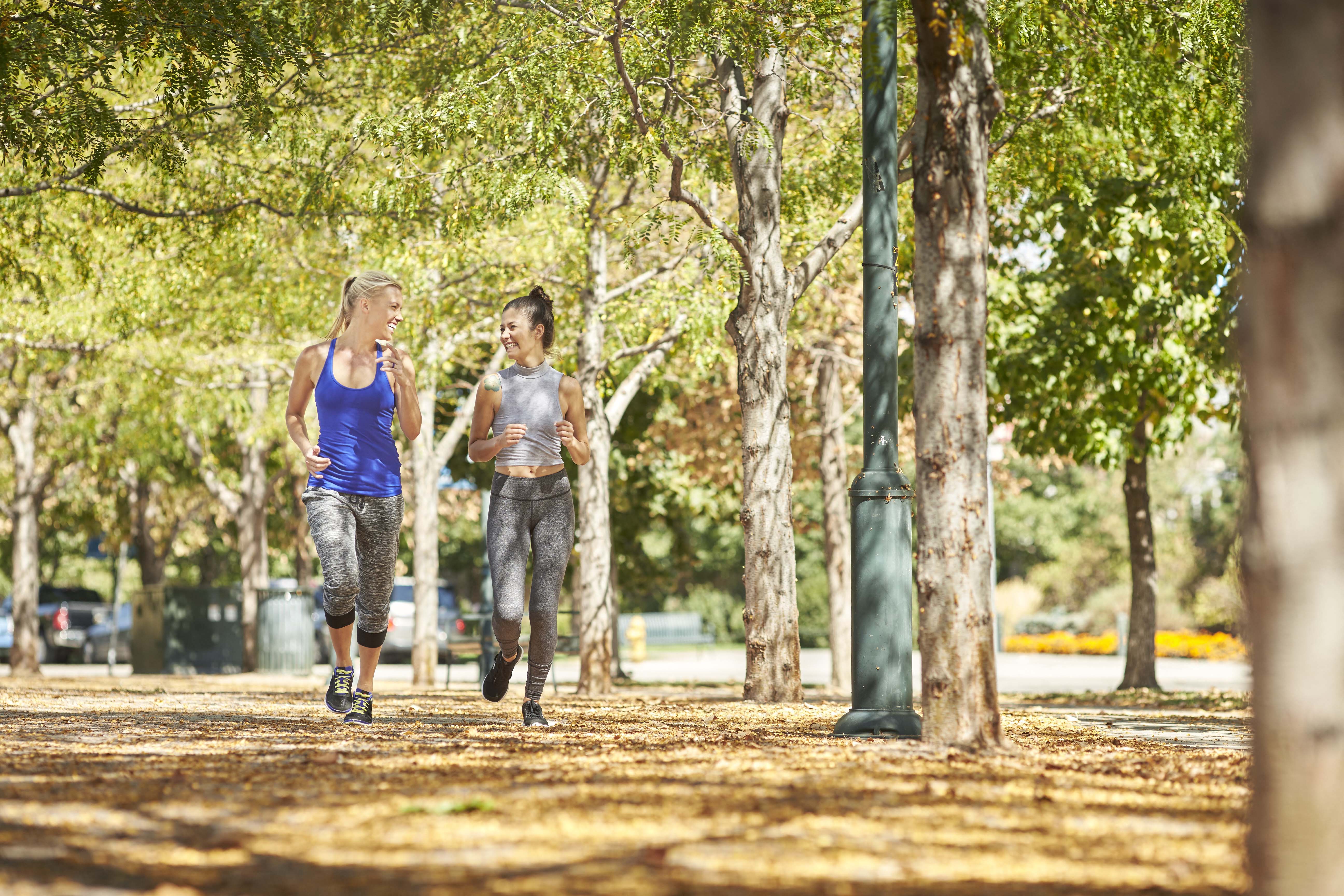 two people running in a park