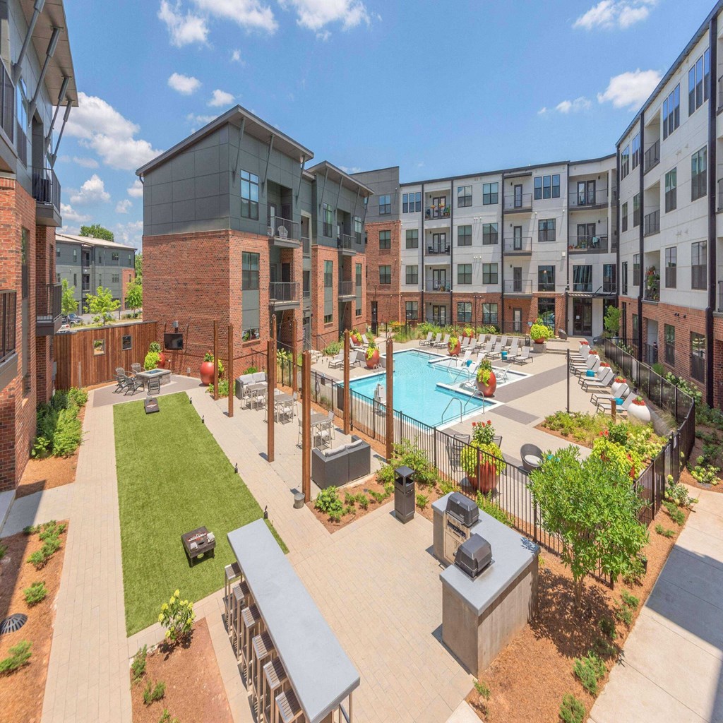 an aerial view of an apartment complex with a swimming pool