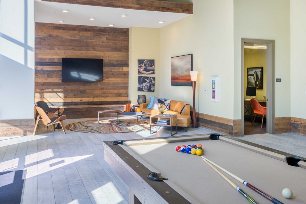 a living room with a pool table and a television