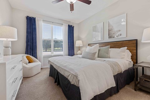 a bedroom with a bed and a ceiling fan