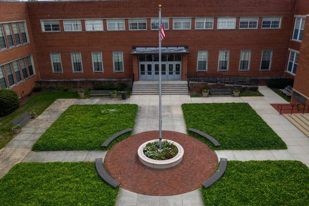 the flag pole in front of the building
