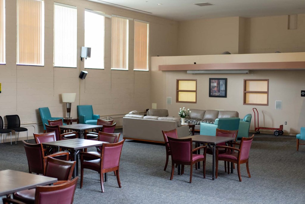 a dining room with tables and chairs and a couch