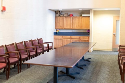 a conference room with a long wooden table and chairs