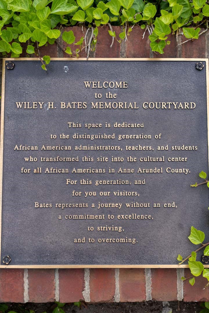 a sign on the side of a brick wall