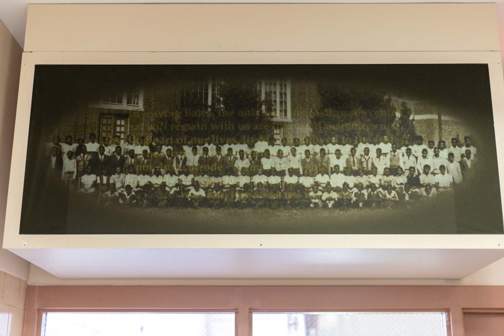 a picture of a group of people hanging on a wall