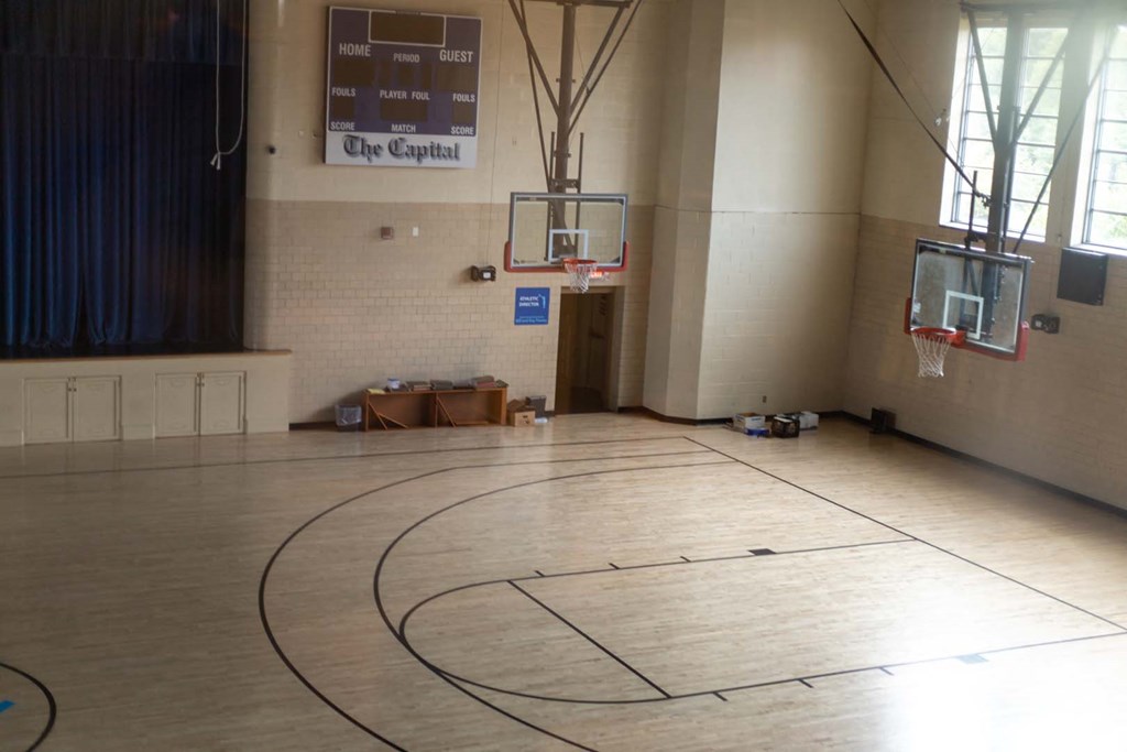 a basketball court in the center of a large room