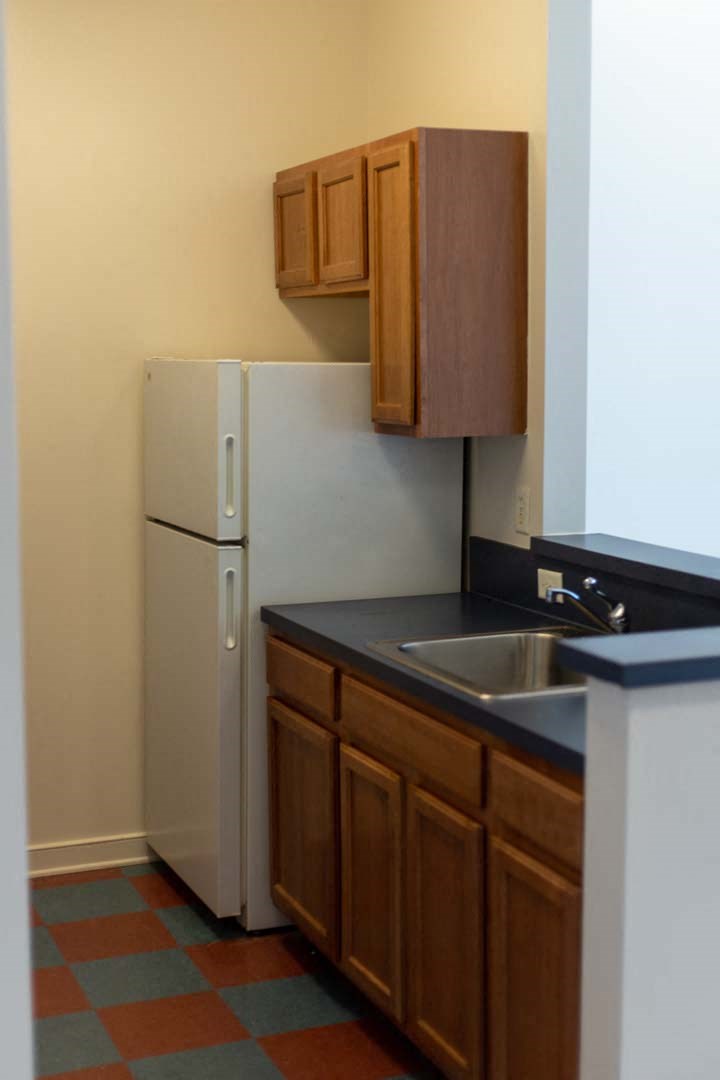 a kitchen with a sink and a refrigerator