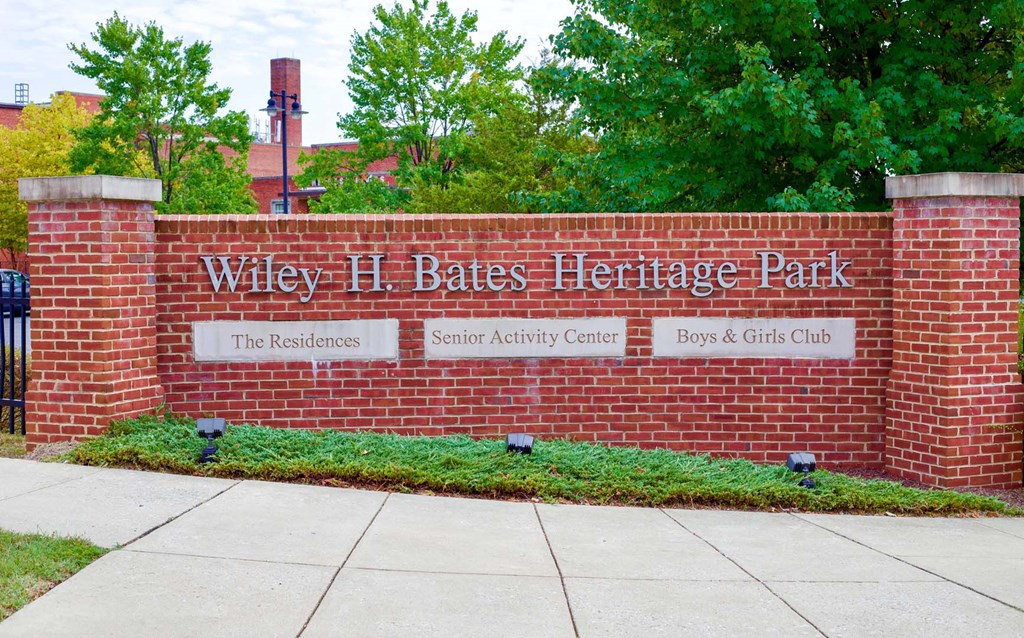 a brick wall with the wiley h gates heritage park sign