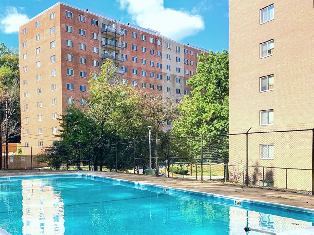 a swimming pool with a building in the background