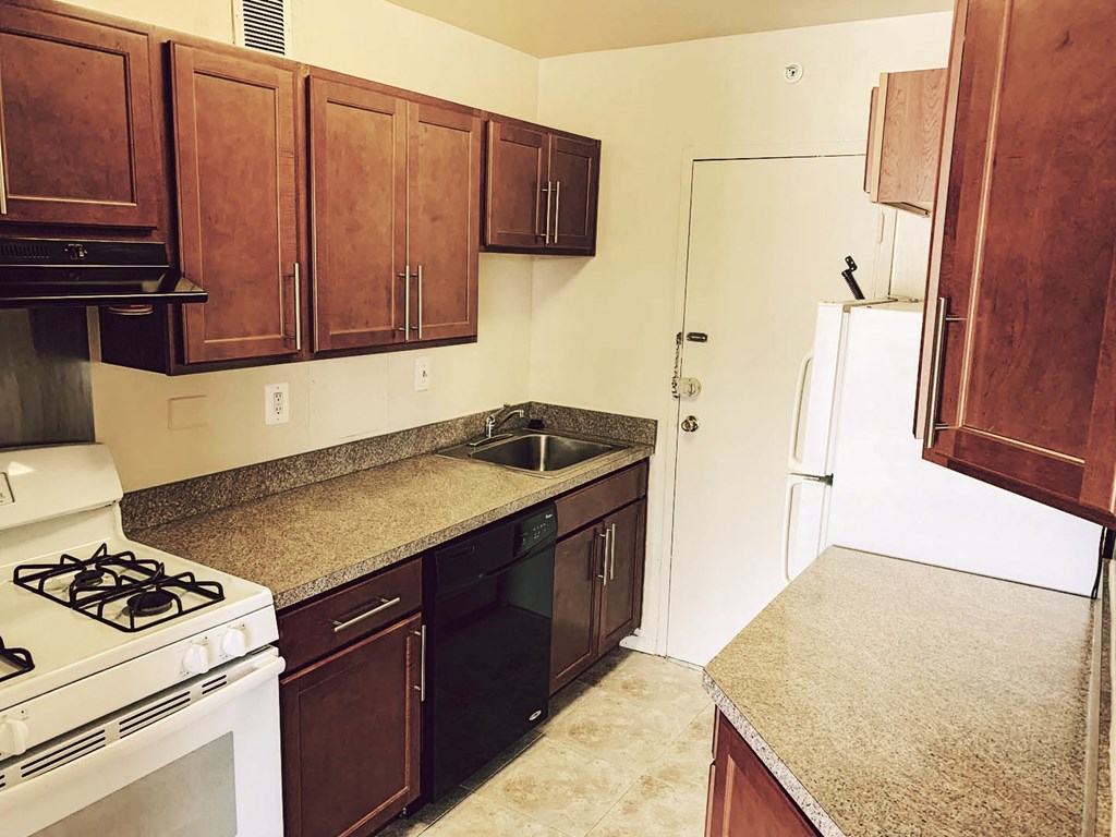 a kitchen with a stove sink and refrigerator
