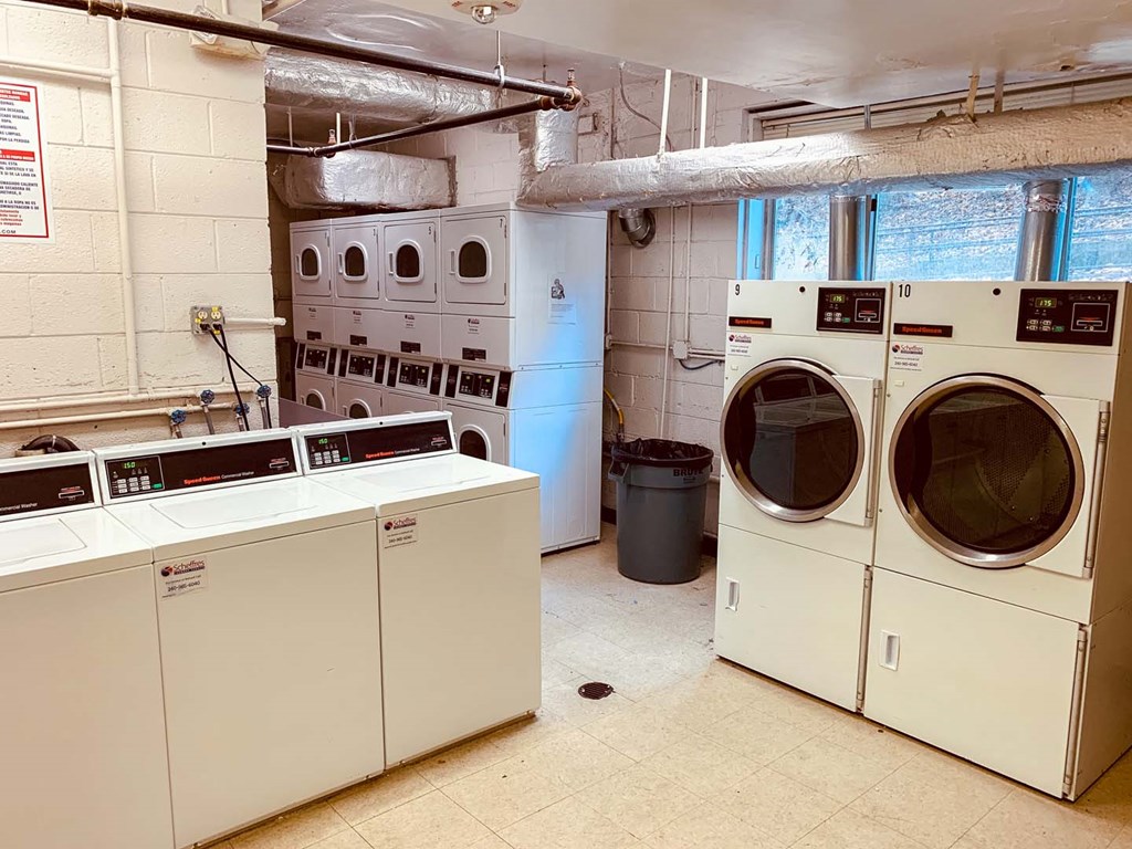 a laundry room with washing machines and dryers in it