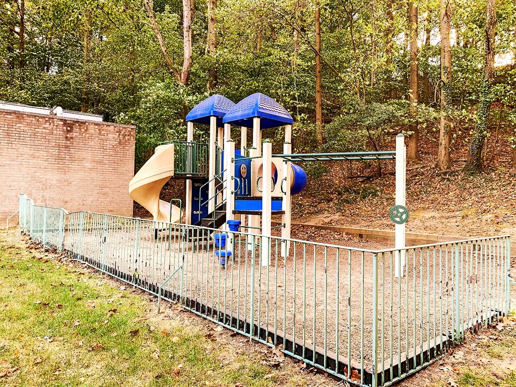 a playground with a swing set and a slide