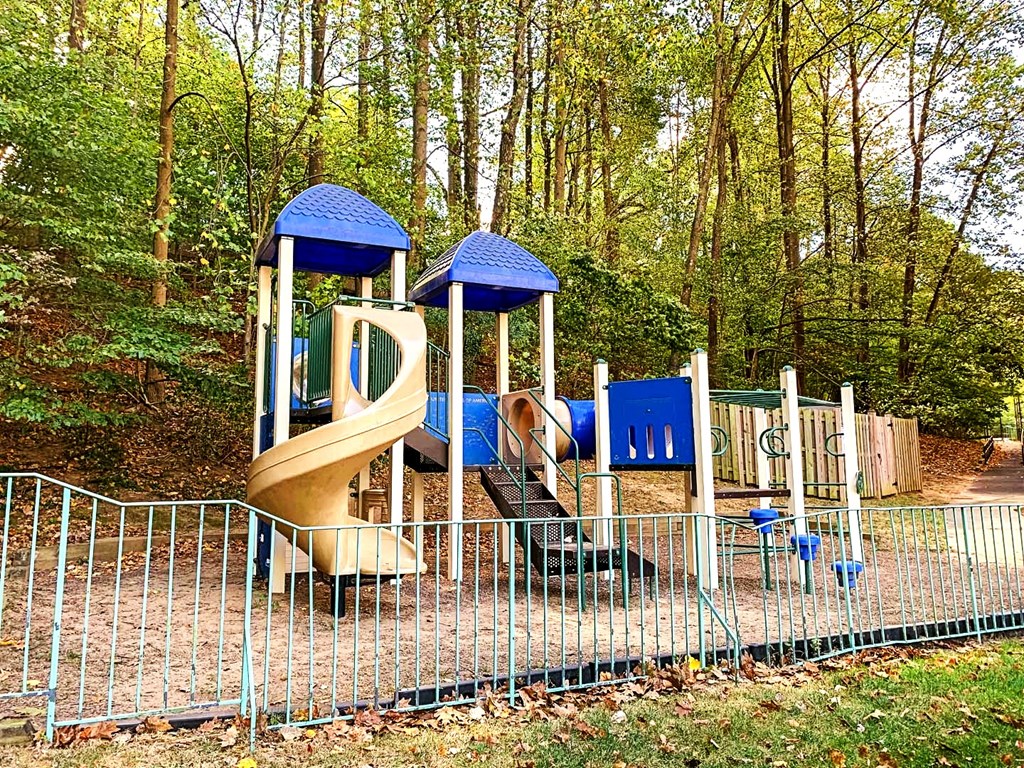 a playground with a slide in a park