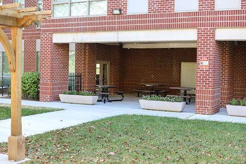 a building with tables and benches outside of it