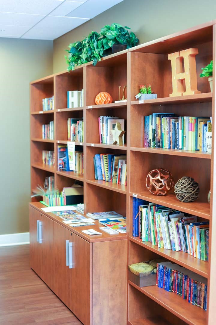 a childrens library with a wooden bookshelf filled with books
