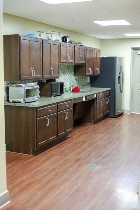 a kitchen with wooden cabinets and a refrigerator
