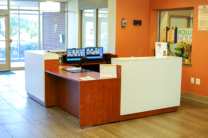 a reception desk with two monitors on top of it