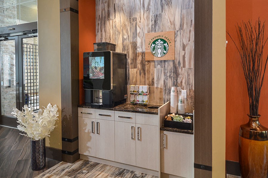 the lobby of a starbucks store with a coffee maker and a television