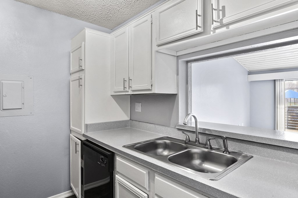 the kitchen of our studio apartment atrium with sink and window