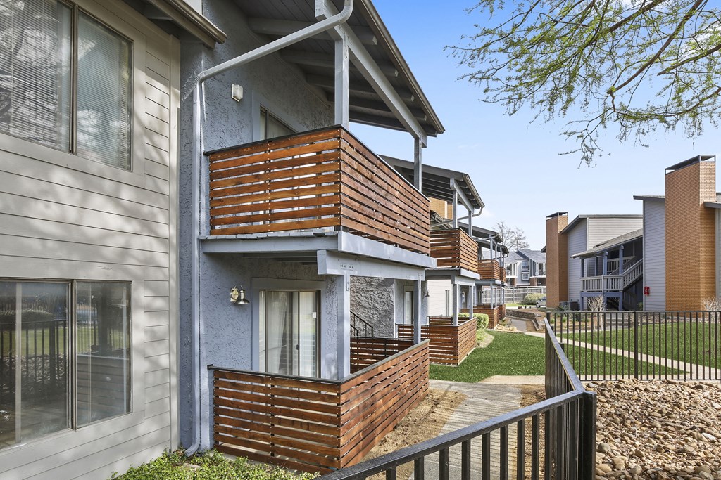 a row of houses with a sidewalk in front of them