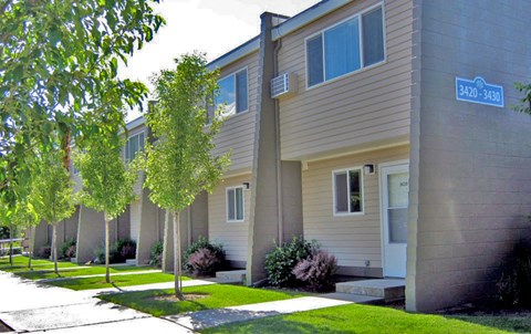 a row of houses with trees in front of them