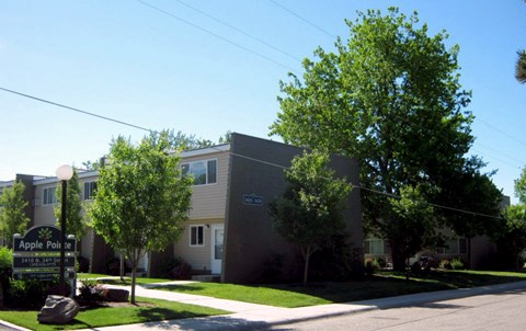 an apartment building with trees in front of it