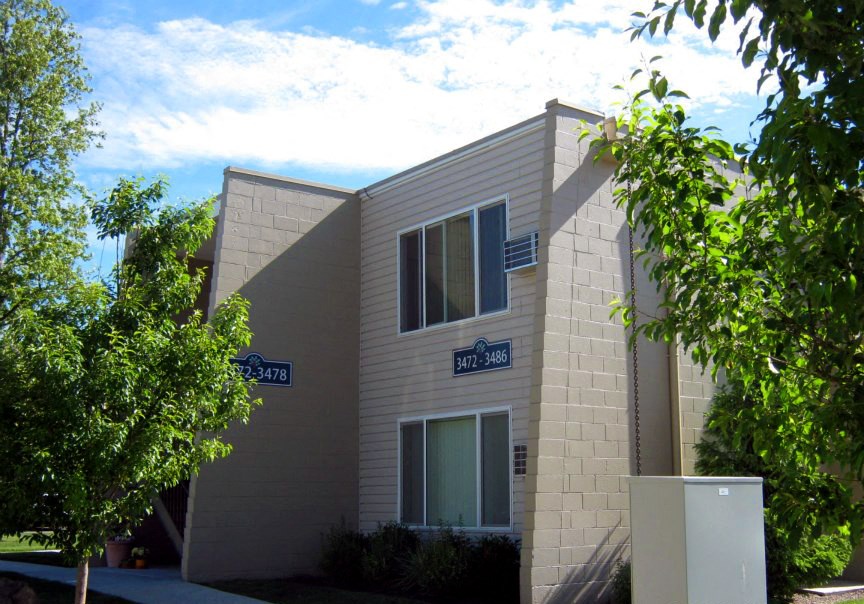 a white building with blue signs on the side of it