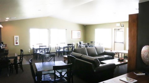 a living room and dining room with couches and tables