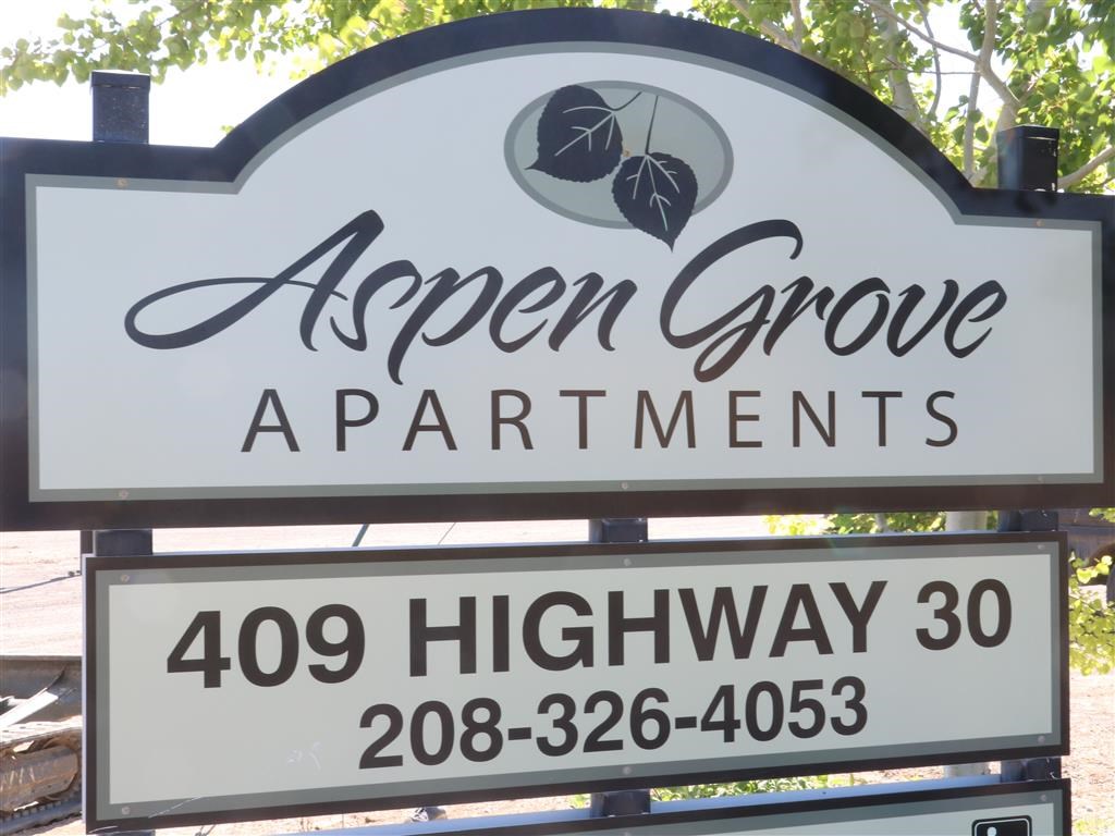 a sign that reads apen grove apartments 395 highway 30