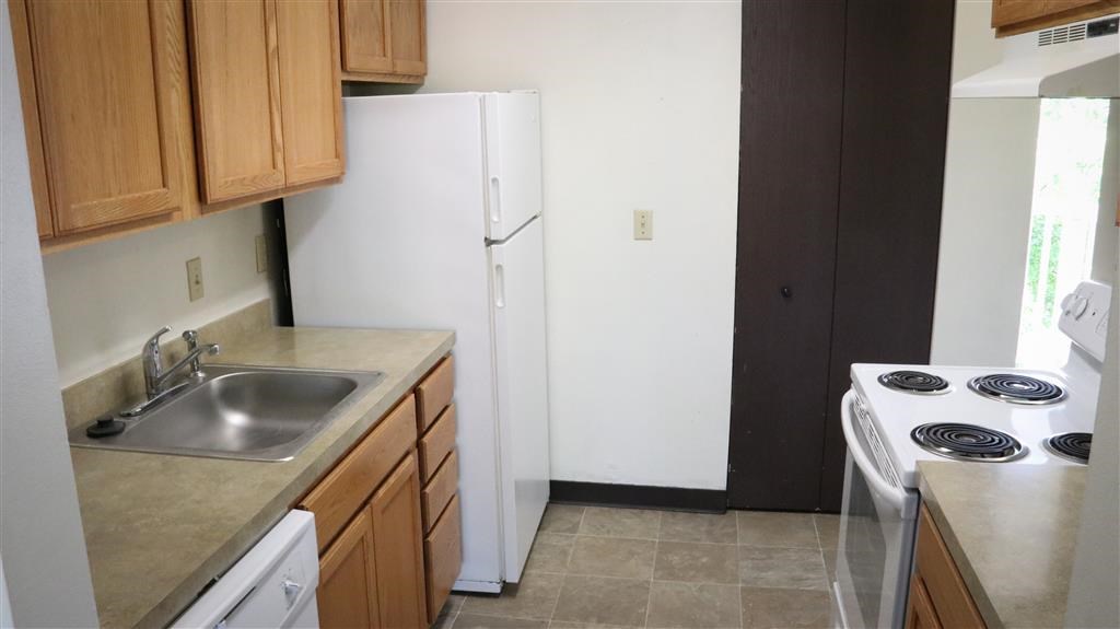 a kitchen with a stove and a refrigerator