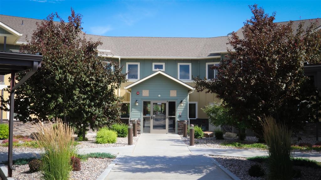 a blue house with a sidewalk in front of it