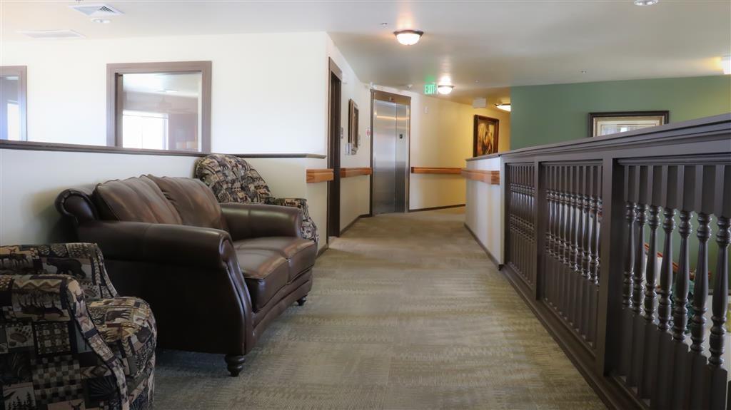 a living room with two leather chairs and a hallway