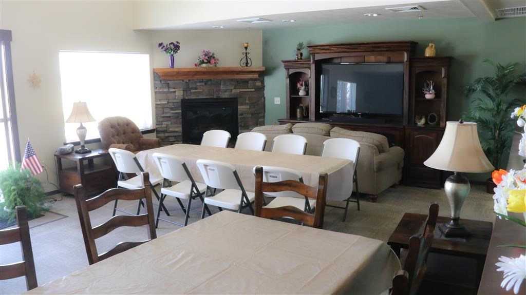 a living room with a table and chairs and a television