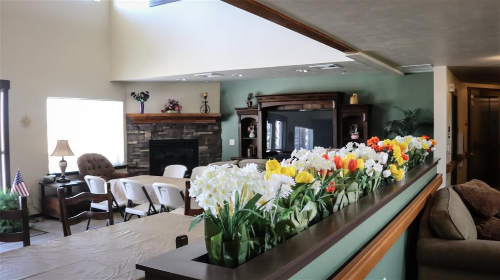 a living room with a bunch of flowers on a counter