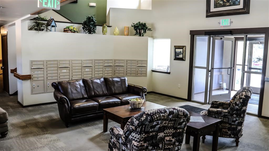 a living room with a leather couch and chairs