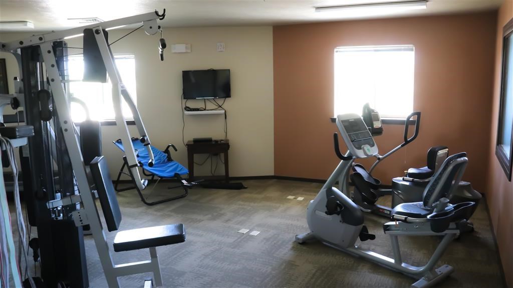 a gym with exercise equipment and a tv