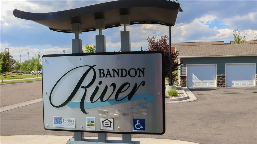 a river sign in front of a gas station
